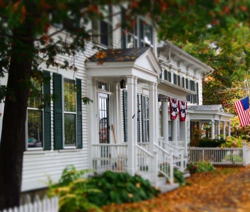 White house in fall flying American flag
