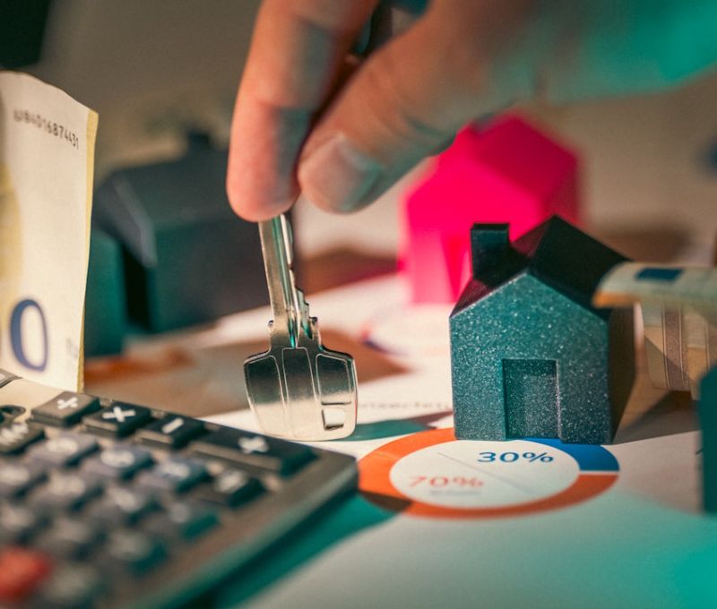 A person putting money into a calculator